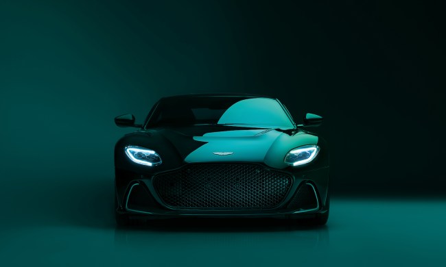 Front end close up of 2023 Aston Martin DBS 770 Ultimate in front of a dark green studio wall.