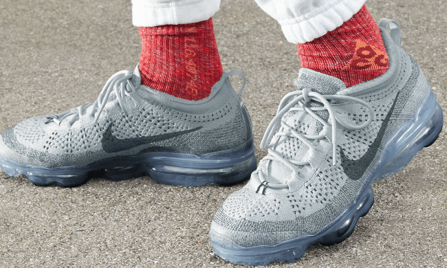 A close up of someone wearing the Nike Air VaporMax where you can only see the bottom of their legs and the shoes.