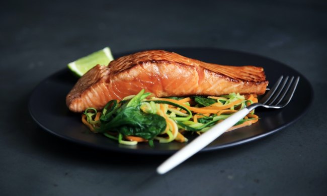 a plate of salmon on dark backdrop