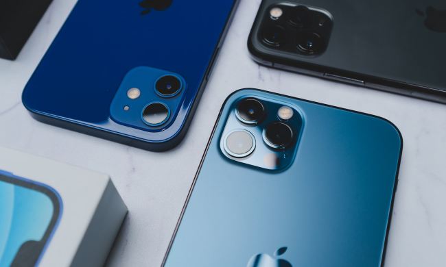 Various iPhones on a table.